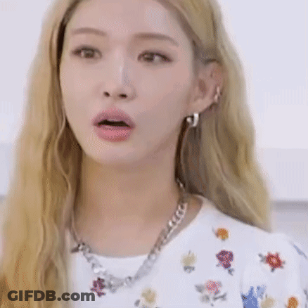 A Woman With Blonde Hair Is Wearing A Necklace And Earrings . GIF