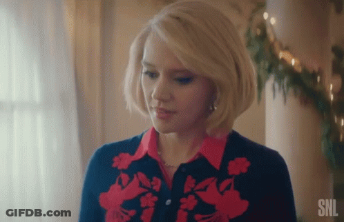 A Woman With Blonde Hair Is Wearing A Red And Blue Sweater And A Red Shirt . GIF