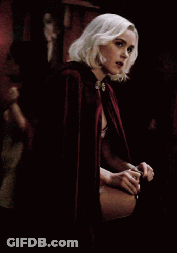 A Woman With Blonde Hair Is Wearing A Red Cape With A Hood GIF