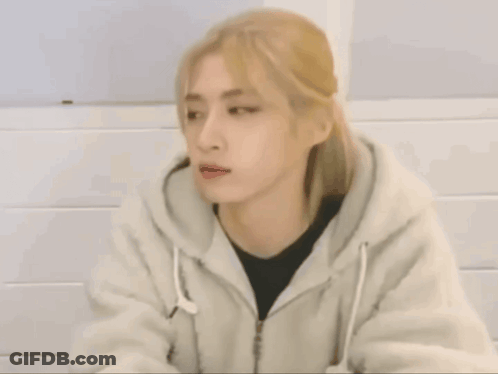 A Woman With Blonde Hair Is Wearing A White Jacket GIF