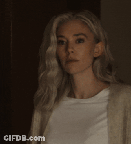 A Woman With Blonde Hair Is Wearing A White Shirt GIF