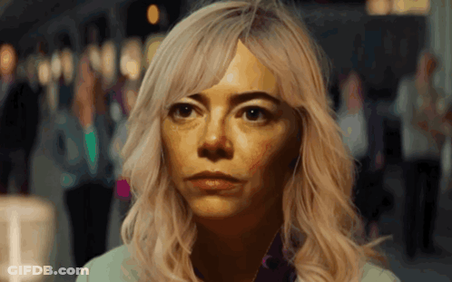 A Woman With Blonde Hair Looks At The Camera GIF