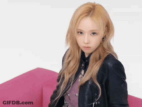 A Woman With Blonde Hair Wearing A Black Leather Jacket GIF