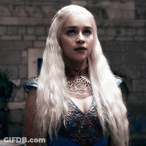 A Woman With Blonde Hair Wearing A Blue And Gold Dress GIF