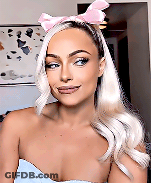 A Woman With Blonde Hair Wearing A Pink Headband GIF