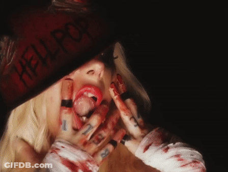 A Woman With Blood On Her Face And A Hat That Says Hell Pop GIF