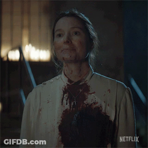 A Woman With Blood On Her Face And A Netflix Logo On The Bottom Right GIF