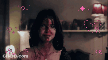 A Woman With Blood On Her Face Is Surrounded By Hearts And Arrows GIF