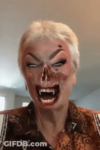 A Woman With Blood On Her Face Is Wearing A Shirt With The Letter V On The Sleeve GIF
