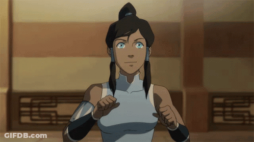 A Woman With Blue Eyes And A Ponytail Is Standing In Front Of A Wall GIF