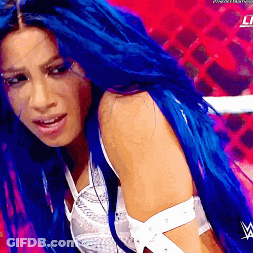 A Woman With Blue Hair And A W Logo On Her Shoulder GIF
