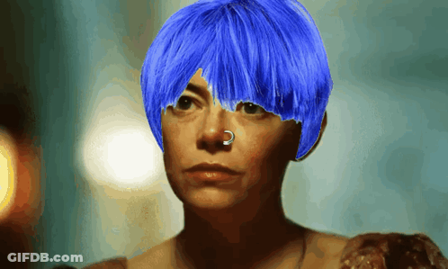 A Woman With Blue Hair Has A Nose Ring On Her Nose GIF