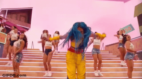A Woman With Blue Hair Is Dancing With A Group Of Women On Stairs . GIF