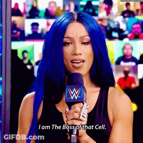 A Woman With Blue Hair Is Holding A Microphone That Says I Am The Boss Of That Cell GIF