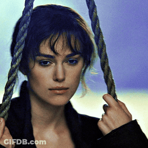 A Woman With Blue Hair Is Holding A Rope Around Her Head GIF