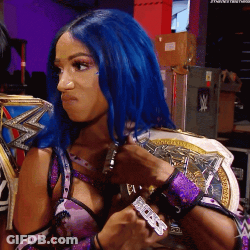 A Woman With Blue Hair Is Holding A Wrestling Championship GIF
