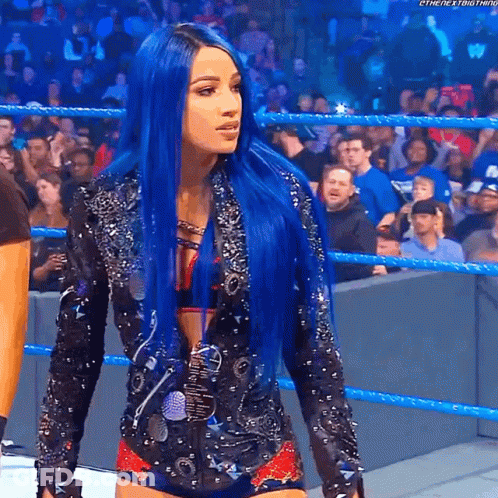 A Woman With Blue Hair Is In A Wrestling Ring GIF