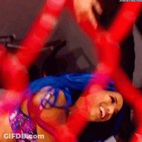 A Woman With Blue Hair Is Laying On Her Back With Her Arms Outstretched GIF