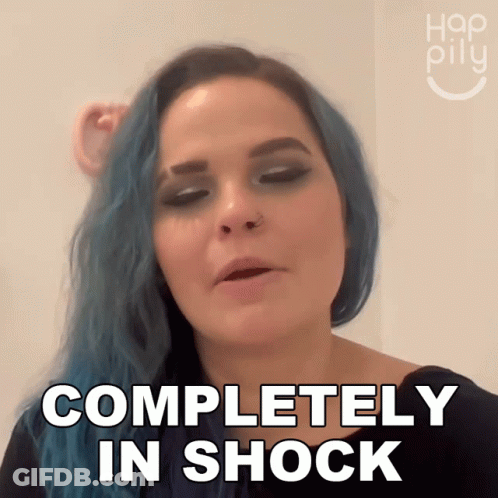 A Woman With Blue Hair Is Making A Face And Says Completely In Shock GIF