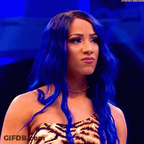 A Woman With Blue Hair Is Making A Funny Face GIF