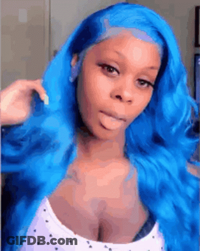 A Woman With Blue Hair Is Making A Funny Face While Wearing A White Tank Top . GIF