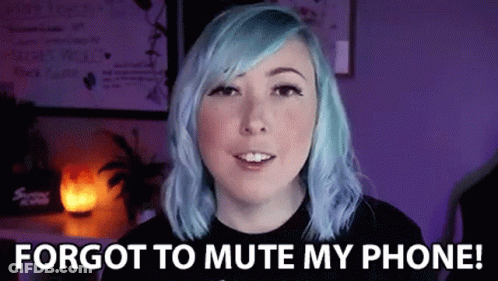 A Woman With Blue Hair Is Standing In Front Of A Purple Wall . GIF