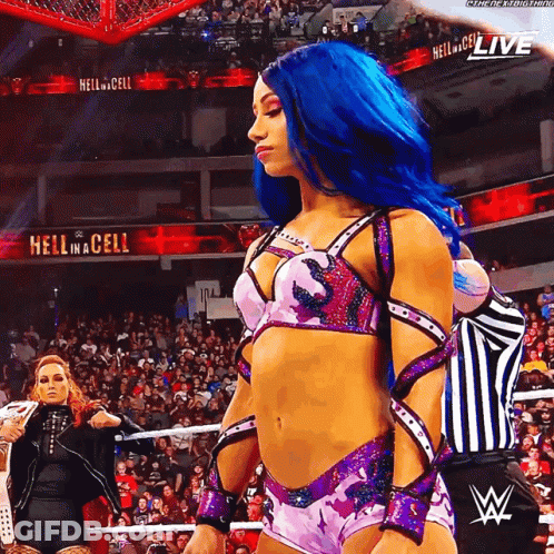A Woman With Blue Hair Is Standing In Front Of A Sign That Says " Hell In A Cell " GIF
