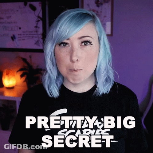 A Woman With Blue Hair Is Wearing A Black Shirt That Says Pretty Big Scare Secret GIF