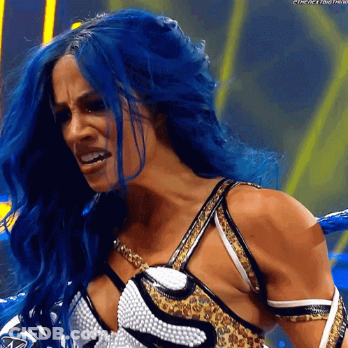 A Woman With Blue Hair Is Wearing A Leopard Print Top GIF
