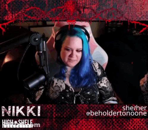 A Woman With Blue Hair Sitting In Front Of A Microphone With The Name Nikki GIF