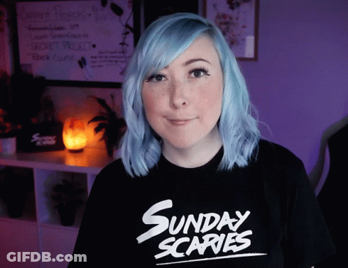 A Woman With Blue Hair Wears A Sunday Scaries Shirt GIF