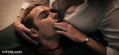 A Woman With Blue Nail Polish Is Kissing A Man On The Neck GIF