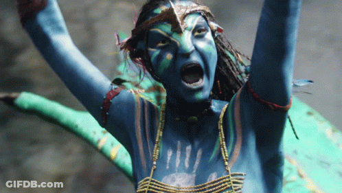 A Woman With Blue Paint On Her Body Is Screaming With Her Arms In The Air GIF