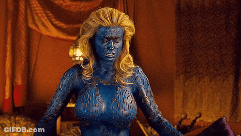 A Woman With Blue Paint On Her Body Is Standing In A Room With Her Arms Outstretched GIF