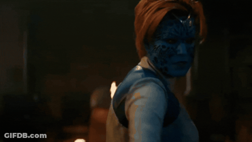 A Woman With Blue Paint On Her Face Is Holding A Sword GIF