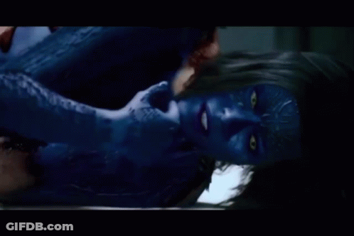 A Woman With Blue Paint On Her Face Is Laying Down GIF