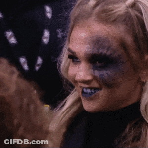 A Woman With Blue Paint On Her Face Smiles GIF