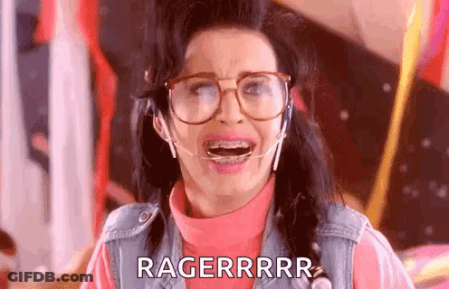 A Woman With Braces On Her Teeth And Glasses Is Making A Funny Face . GIF