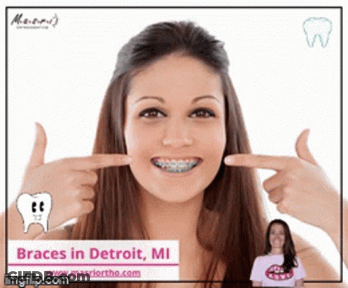 A Woman With Braces On Her Teeth Is Pointing At Her Teeth GIF