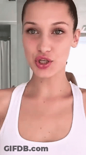 A Woman With Braces On Her Teeth Is Taking A Selfie GIF