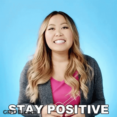 A Woman With Braces On Her Teeth Smiles And Says Stay Positive GIF