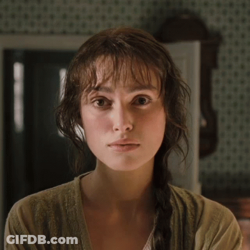 A Woman With Braided Hair Looks At The Camera GIF