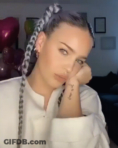 A Woman With Braids Has A Tattoo On Her Wrist That Says " I 'M Okay " GIF