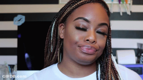 A Woman With Braids Has Her Eyes Closed And A White Shirt On GIF