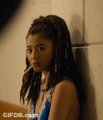 A Woman With Braids In Her Hair Smoking A Cigarette GIF