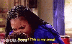 A Woman With Braids Is Covering Her Mouth With Her Hand And Saying , `` Heeey ! This Is My Song ! '' GIF