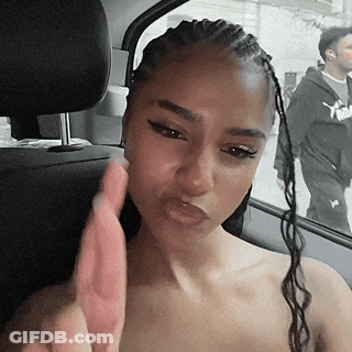 A Woman With Braids Is Sitting In The Back Seat Of A Car Making A Face . GIF