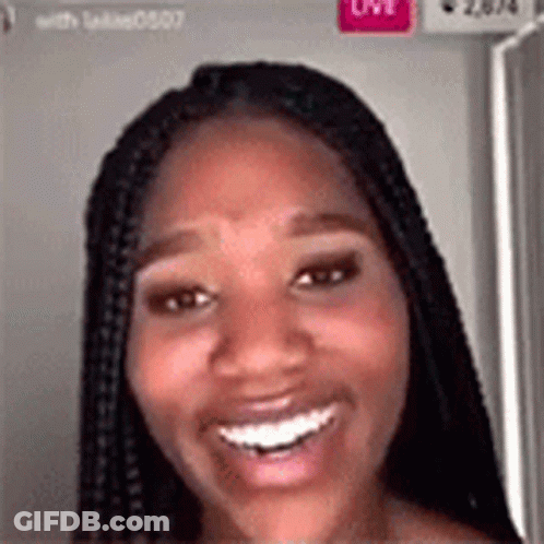A Woman With Braids Is Smiling And Looking At The Camera In A Video Call . GIF