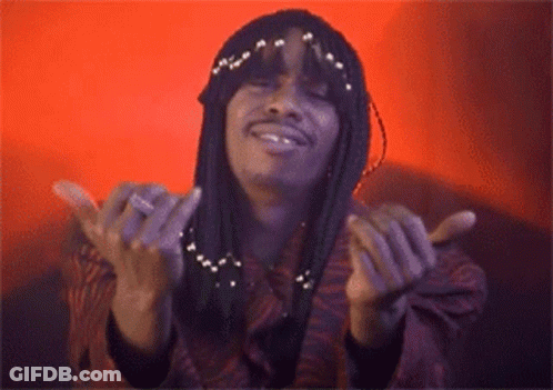 A Woman With Braids Is Smiling With Her Hands Outstretched GIF
