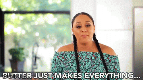 A Woman With Braids Is Standing In Front Of A Window And Saying `` Butter Just Makes Everything ... '' GIF
